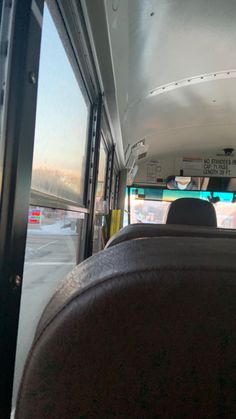 the inside view of a bus with its door open and people in the back seat