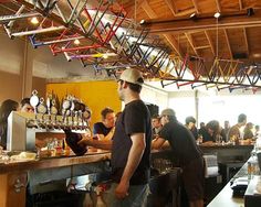 a group of men standing around a bar