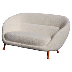 a white couch sitting on top of a wooden frame