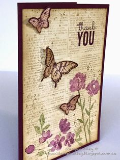 a close up of a card with flowers and butterflies on it's back side