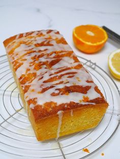 a loaf of orange pound cake on a wire rack