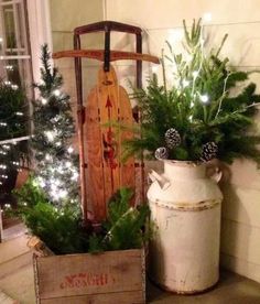 a wooden sled with christmas trees in it next to a potted planter