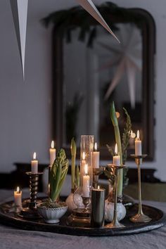 a tray with candles and asparagus on it