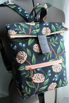 a black and blue bag with flowers on it