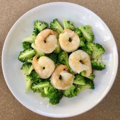 shrimp and broccoli in a white bowl