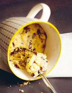 a cup filled with food sitting on top of a table