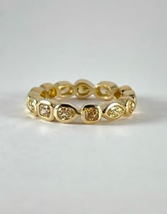 a yellow gold ring with three diamonds on it