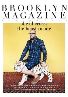 a man sitting on top of a white tiger in front of a yellow background with the words brooklyn magazine