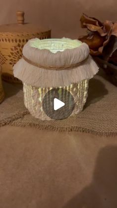 a cupcake sitting on top of a table next to some other items in the background