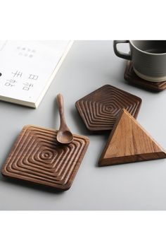 three wooden coasters and a spoon on a table