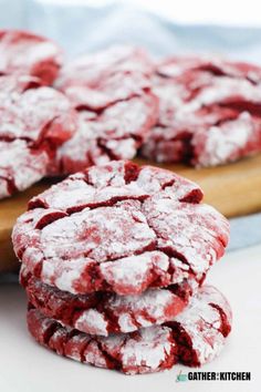 red velvet crinkle cookies stacked on top of each other with powdered sugar