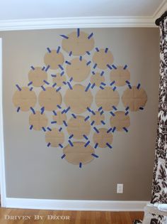 a wall with some cut out pieces of paper on it in the middle of a room