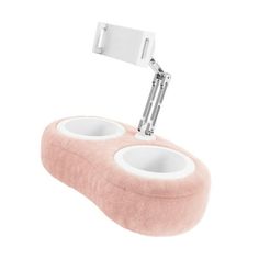 a pink and white object with two cups on it's side, in the shape of a phone holder