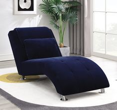 a blue chair sitting on top of a white rug