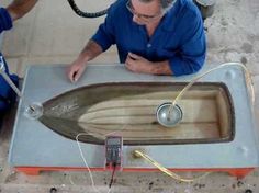 two men working on an old fashioned sink