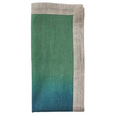 a teal and grey blanket with two different colors on it, one is folded over the