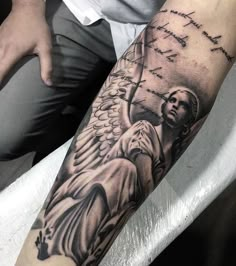 a man's arm with an angel on it and the words instagramm