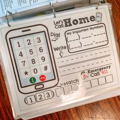 a close up of a cell phone on a clipboard with writing and numbers attached to it