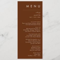 a menu card for a restaurant with the name and date on it, sitting on top of a marble table