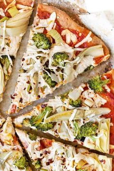 a pizza topped with broccoli and cheese cut into slices