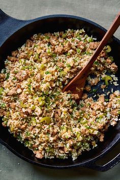 a skillet filled with rice and vegetables