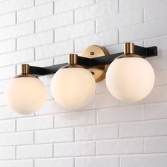 Classic style meets modernism with our Art Deco-inspired frosted globe wall light. Three LED lights cast a warm glow, providing plenty of light. The rich brass-gold finish adds vintage style to your bath vanity, kitchen, hallway or entry. JONATHAN Y Modernist Globe Metal/Frosted Glass Glam 24-in 3-Light Polished Gold LED Mid-century Vanity Light | JYL3542A Farmhouse Vanity Lights, Mid Century Vanity, Globe Wall Light, Farmhouse Vanity, Black Vanity Light, Led Vanity Lights, Black Vanity, Led Vanity