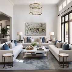 a living room filled with lots of white furniture