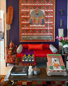 a living room filled with furniture and paintings on the wall