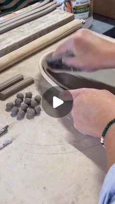 a person is working on some kind of crafting project with beads and woodworking tools