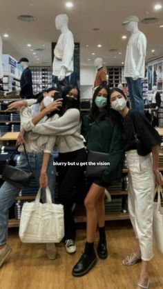 three people wearing masks in a store with bags on their heads and one person standing behind them