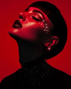 a woman with her eyes closed and stars on her face, in red light photo