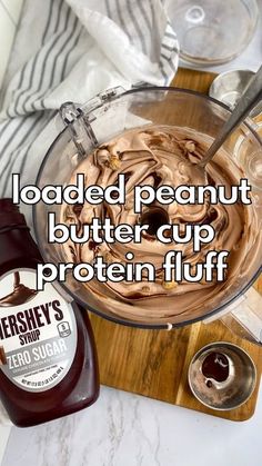 peanut butter cup protein fluff in a glass bowl next to a bottle of ketchup