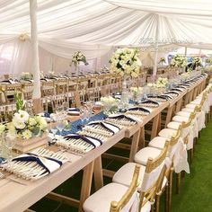 the tables are set up with white and blue linens for an elegant wedding reception