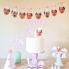 a baby's first birthday party with cake, decorations and photo heads on the wall