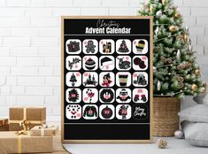 a black and white christmas calendar with presents next to it on a table near a small tree