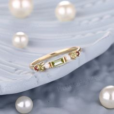 a gold ring with three stones and pearls