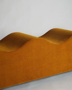 an orange couch with wavy lines on the top and bottom, against a white background