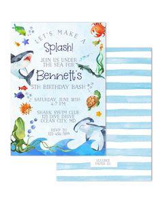 an ocean themed birthday party with blue and white stripes, dolphins, sea animals and fish