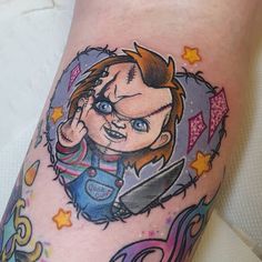 a cartoon character on the side of a woman's leg with tattoos and piercings