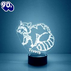 a light up raccoon with the word travis on it