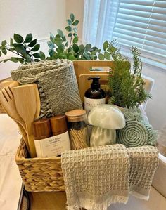 a basket filled with lots of items sitting on top of a bed