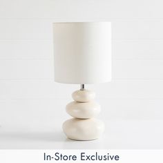 a white lamp sitting on top of a table