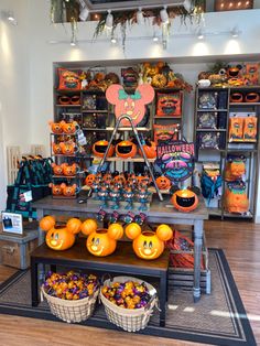 a store filled with lots of pumpkins and decorations