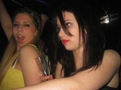 two young women are having fun at a party