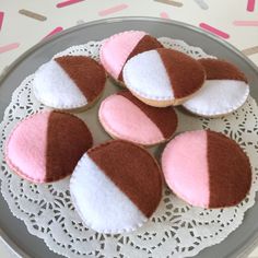 four pink and white cupcakes on a plate