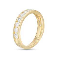 a yellow gold wedding ring with white stones