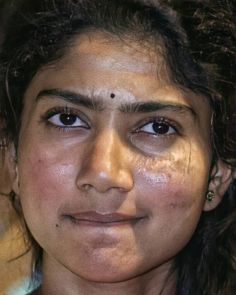 a close up of a woman with freckles on her face