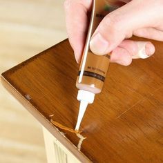 a person is using an electronic device to test the contents of a wooden table top