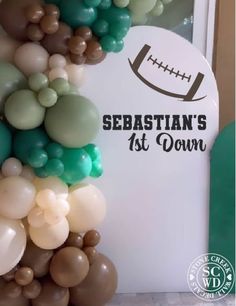 a football themed party with balloons in the shape of an american football and words sebastian's at down