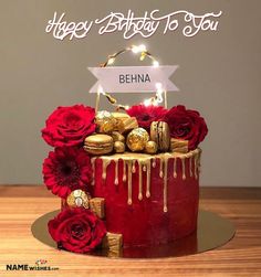 a birthday cake with red roses and chocolates on the top that says happy birthday to you priya